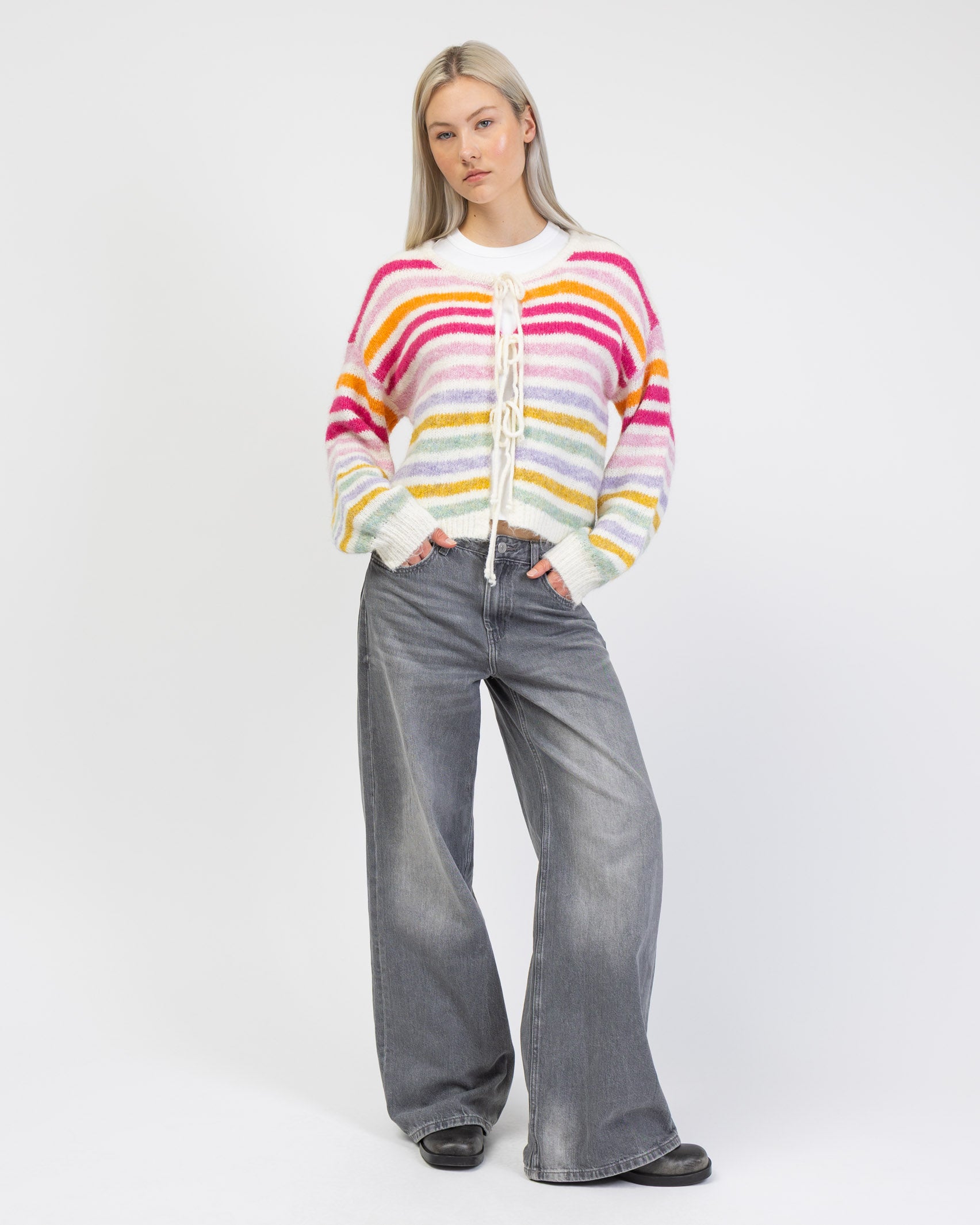 Gestreifte Strickjacke mit Bindebändern kombiniert mit grauer Hose