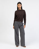 Strickjacke mit asymmetrischer Knopfleiste mit grauer Hose kombiniert