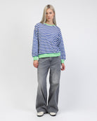 Gestreiftes Sweatshirt mit Farbakzenten kombiniert mit grauer Jeans